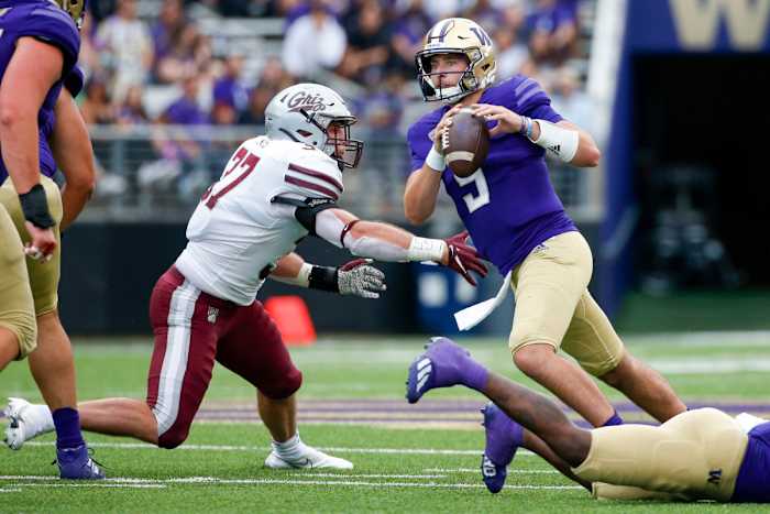 Washington quarterback Dylan Morris (9) avoids a sack and looks to throw against Montana.